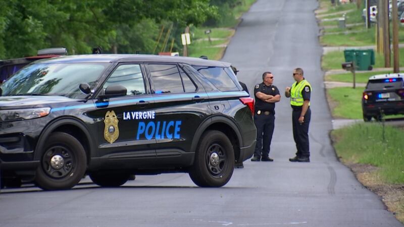 Police officers block the roadway following the incident while they investigate.