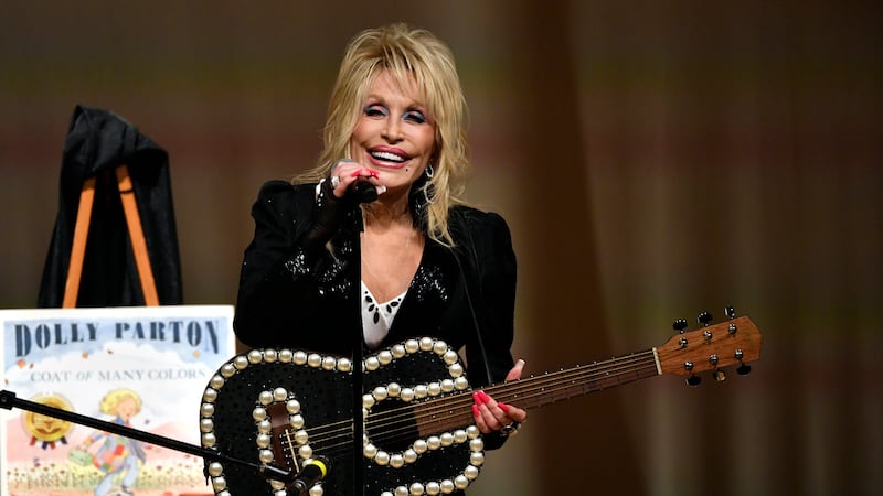 Dolly Parton plays to an audience gathered to celebrate the expansion of the Imagination...