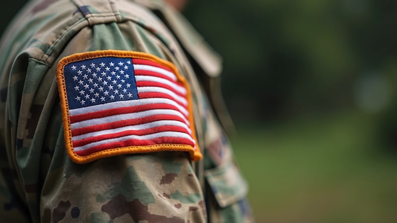 Close-up of U. S. military uniform with American flag patch. Soldier detail, national emblem....