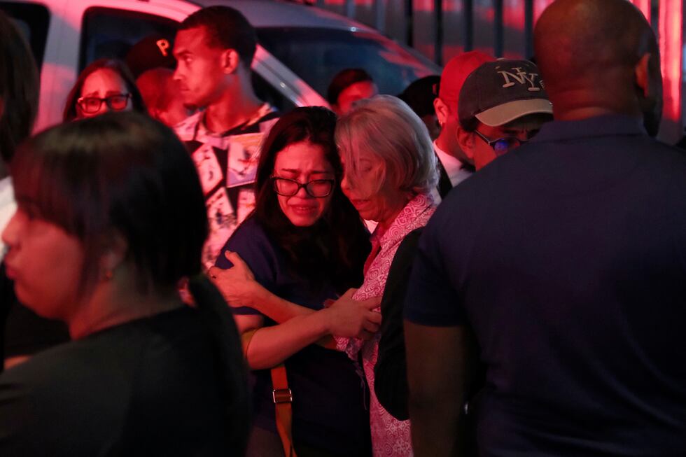 Parientes de personas desaparecidas se abrazan mientras esperan ante el Instituto Nacional de...